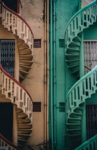 Colorful spiral staircases on urban buildings.