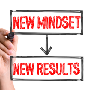 Hand writing 'New Mindset New Results' on transparent boards.