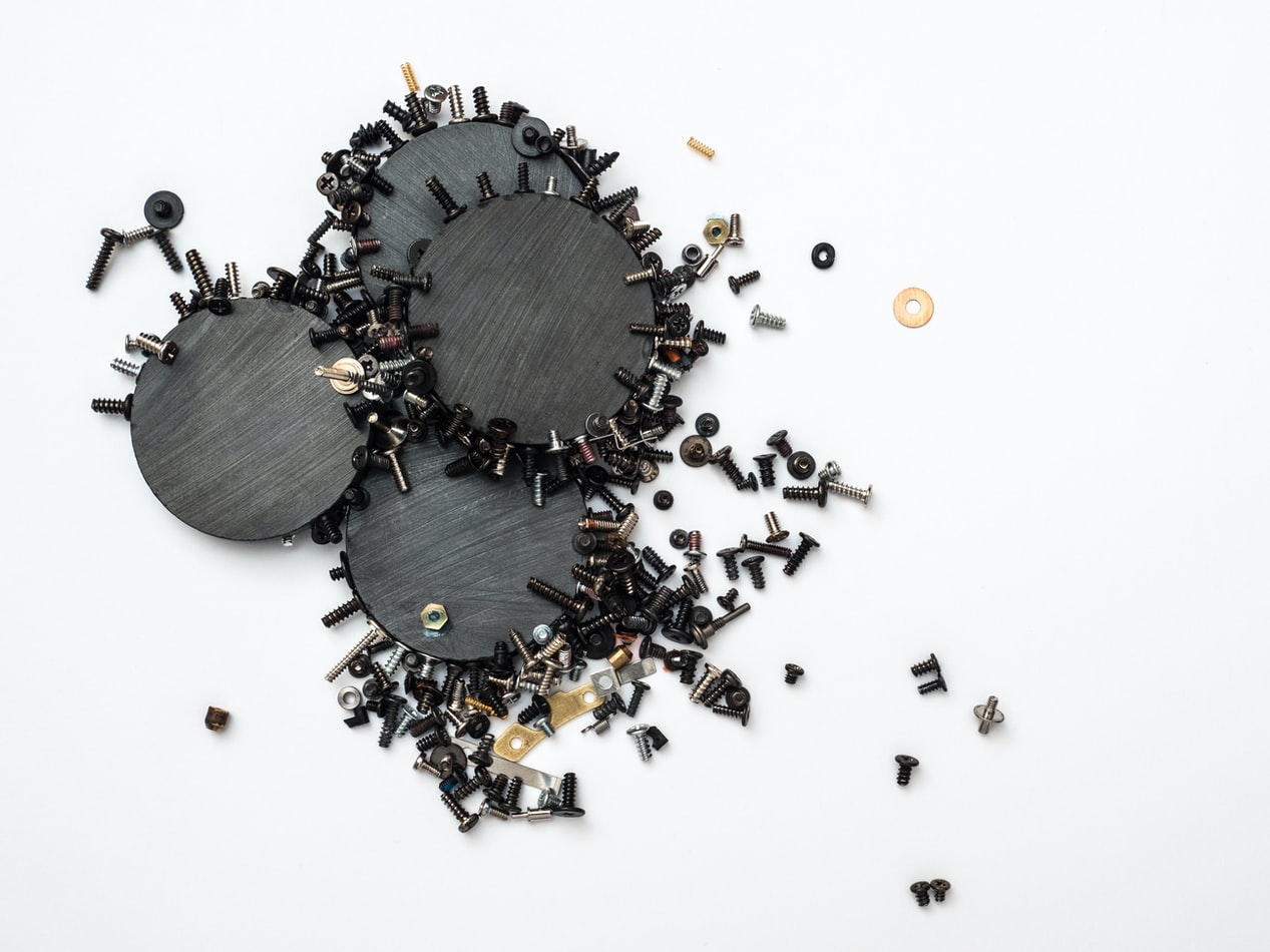 Various screws and washers arranged on white background.