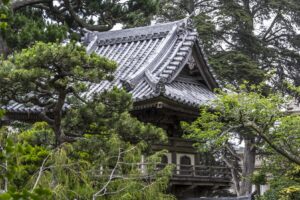 Traditional Japanese pagoda surrounded by lush greenery.