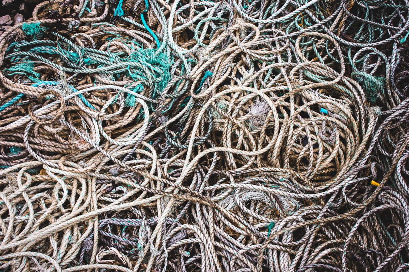 Tangled heap of weathered ropes and fishing nets.