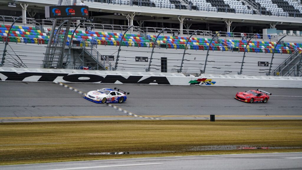 Race cars speeding on Daytona International Speedway.