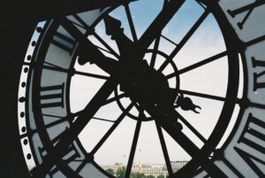 View through Musée d'Orsay clock towards Paris skyline.