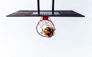 Basketball swishing through net in outdoor hoop.