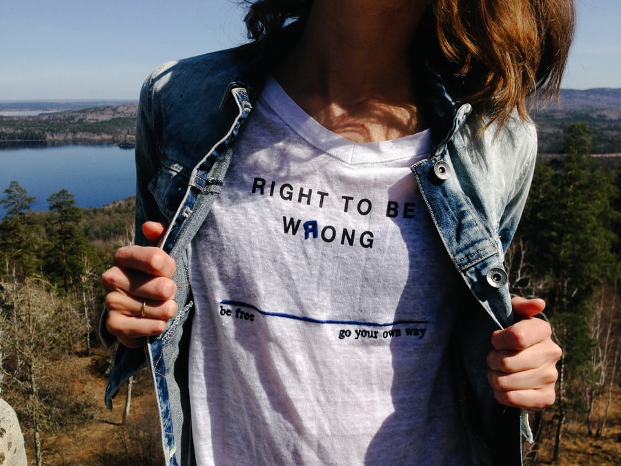 Woman in t-shirt with scenic lake view background.