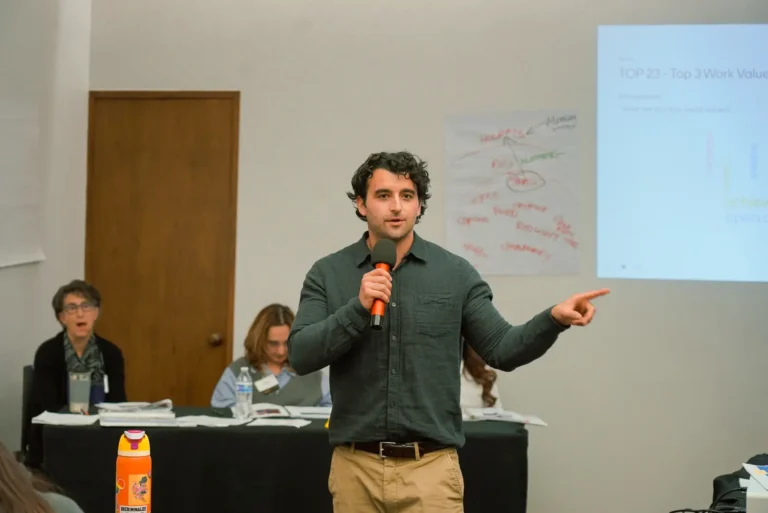 Man presenting at workshop with microphone