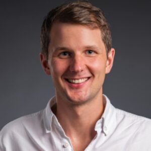 Smiling man in white shirt posing for photo