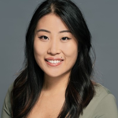 Smiling Asian woman with long dark hair, professional headshot