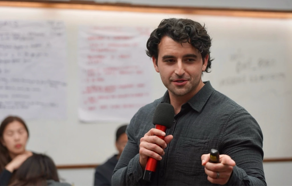 Man holding microphone speaking at public event