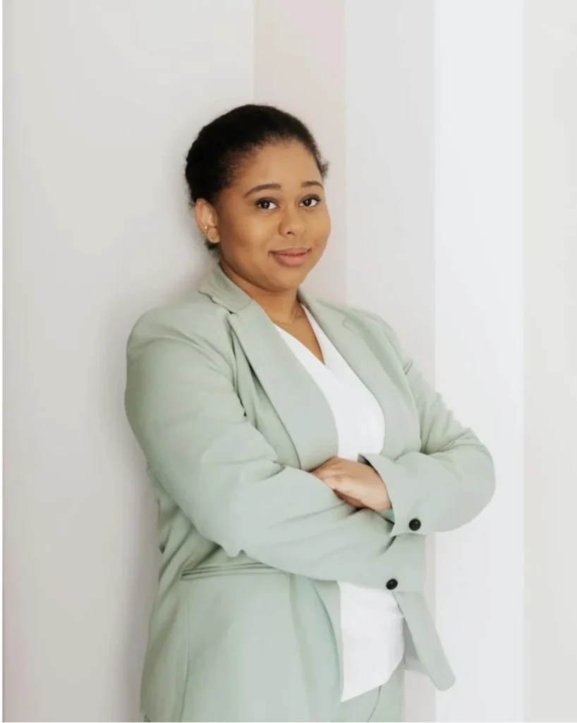 Confident businesswoman in light green blazer smiling
