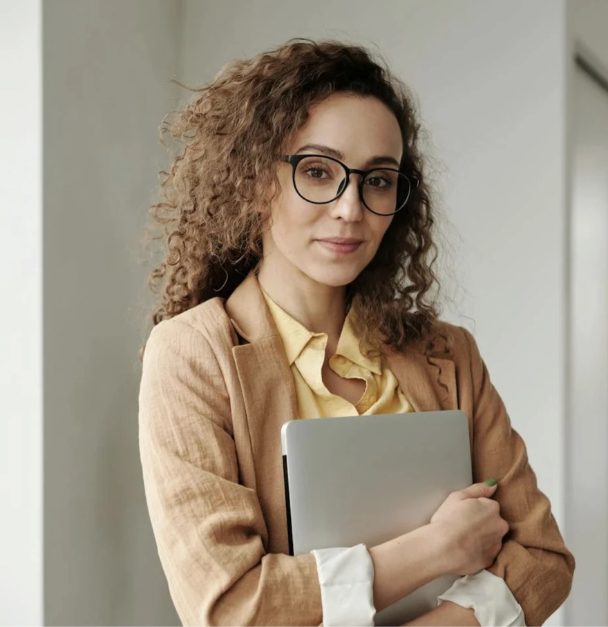Professional woman holding laptop in modern office