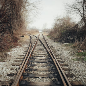 Railway tracks splitting in foggy rural landscape