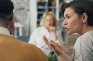 Woman speaking during small group office meeting
