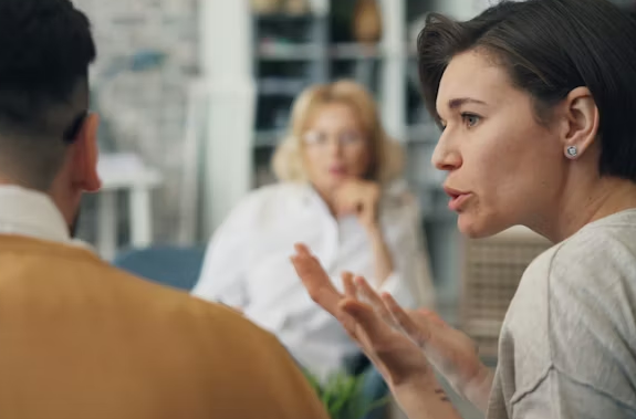 Woman speaking during small group office meeting